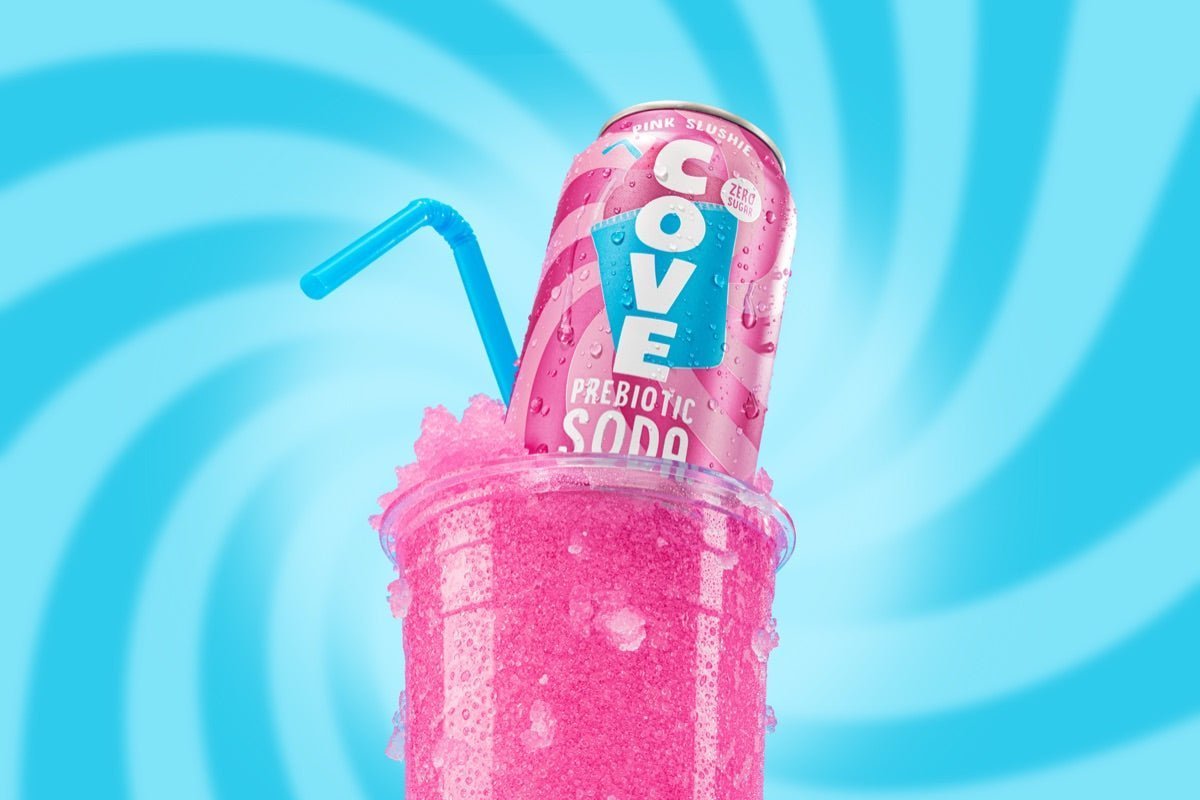Cove Pink Slushie can resting in a frosty pink slush cup with a blue straw