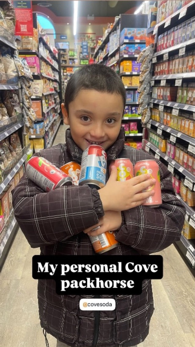 A young fan with an armful of Cove cans