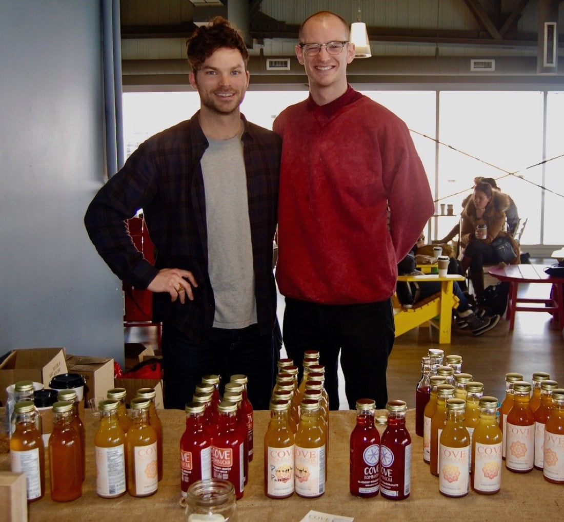 The two founders behind their Cove Kombucha farmers’ market table