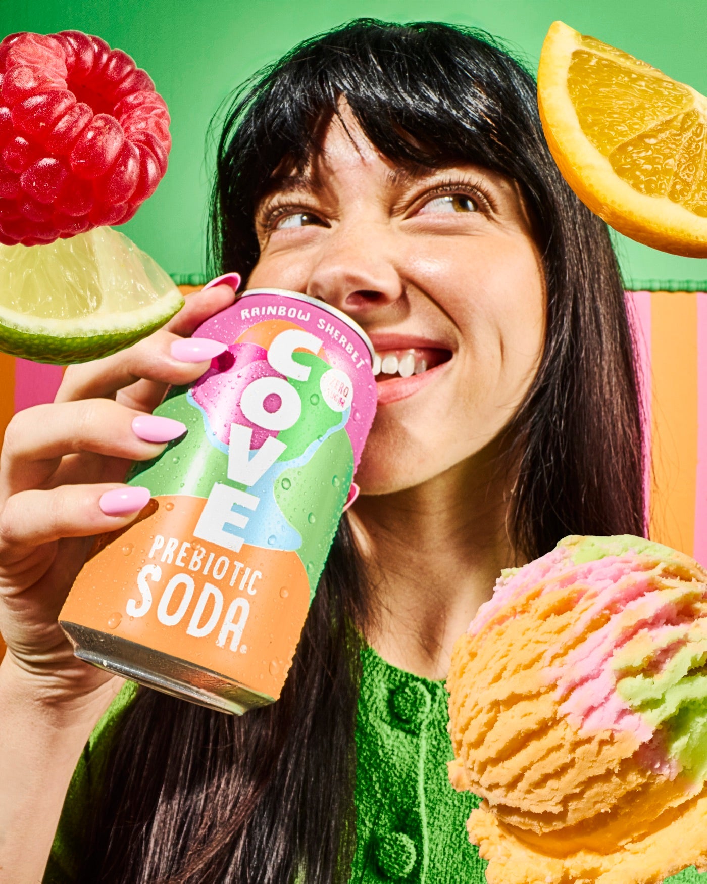 A smiling woman sipping a Cove Rainbow Sherbet can