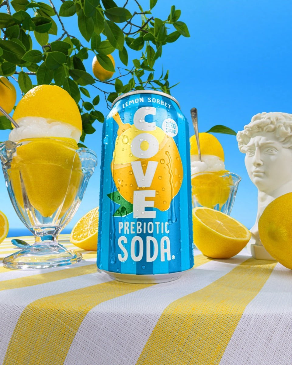 Cove Lemon Sorbet can on a gingham table with lemons, a sorbet coupe and a classical bust