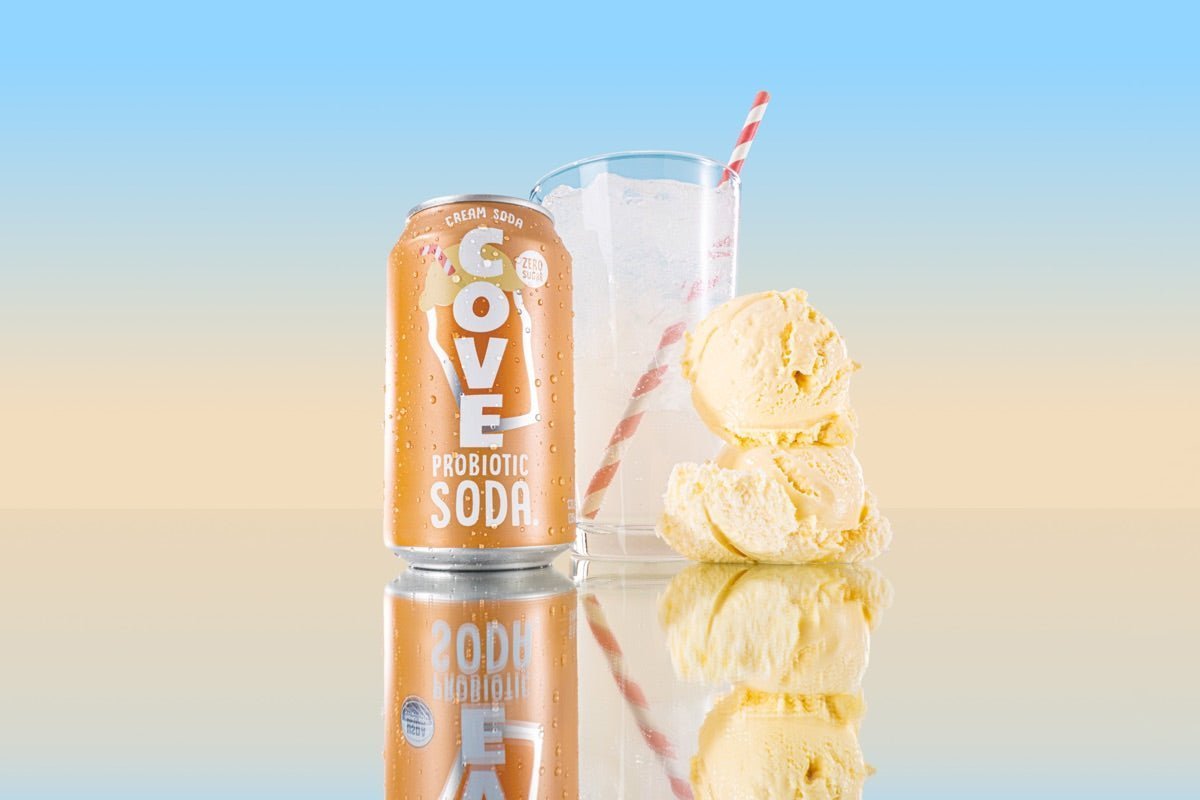 Cove Cream Soda can beside a glass of ice and stacked vanilla ice-cream scoops with a striped straw